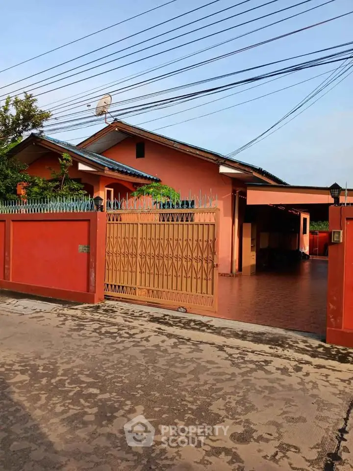 Charming single-story home with gated entrance and spacious driveway, perfect for family living.