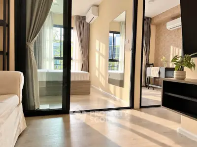 Modern apartment interior with mirrored closet and natural light
