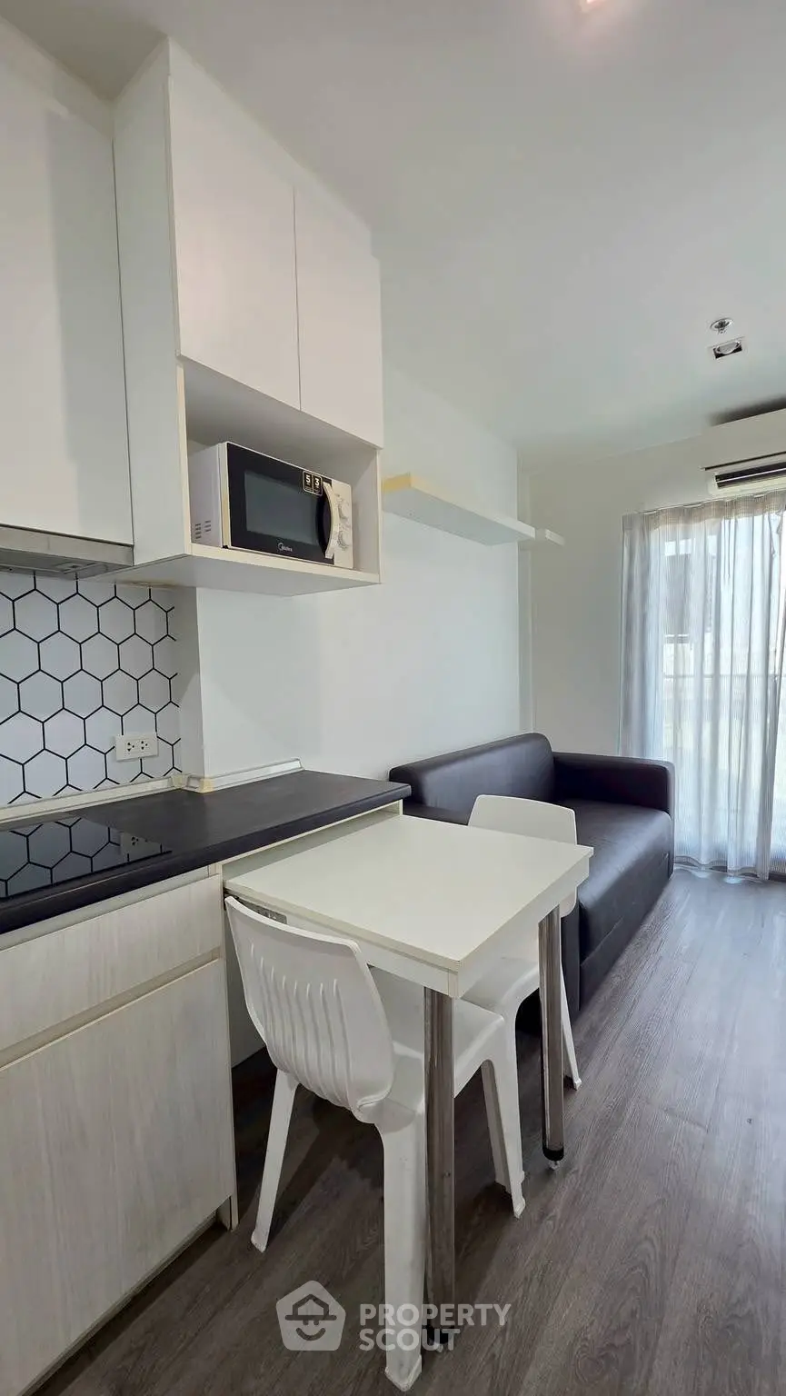 Modern compact kitchen with sleek design and cozy dining area