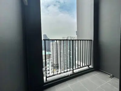 High-rise balcony with stunning cityscape view and modern railing design.