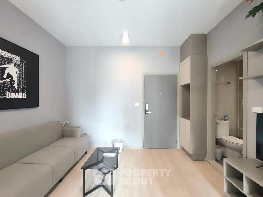 Modern living room with sleek furniture and minimalist design, featuring a cozy sofa and stylish coffee table.