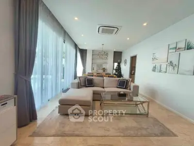 Spacious modern living room with elegant decor and large windows for natural light.