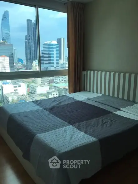 Spacious bedroom with city view in modern high-rise apartment