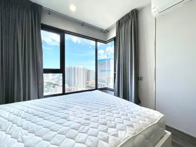 Modern bedroom with panoramic city view and large windows