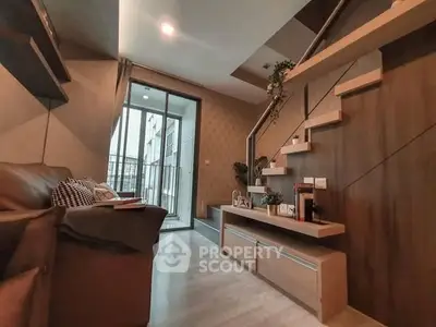 Modern living room with stylish staircase and balcony access