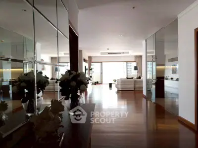 Spacious modern living room with mirrored walls and elegant decor