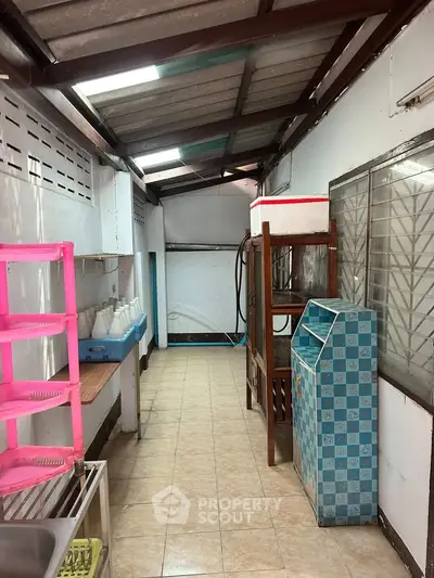 Spacious utility area with ample storage and natural light, perfect for organizing household essentials.
