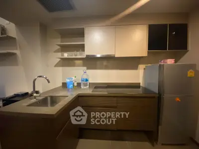 Modern kitchen with sleek cabinets and stainless steel appliances in a stylish apartment.