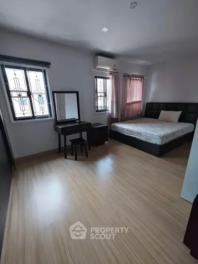 Spacious bedroom with modern decor and natural light