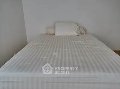 Minimalist bedroom with striped bedding and white pillows