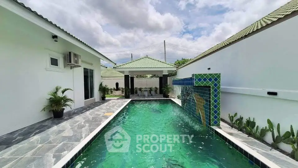 Luxurious private pool with modern design and lush greenery in a serene residential setting.
