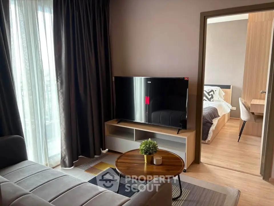 Modern living room with TV and cozy bedroom view in stylish apartment