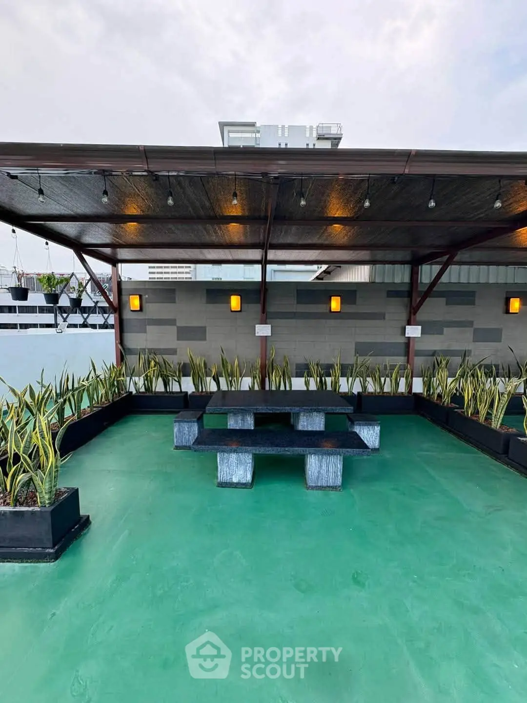 Stylish rooftop area with modern seating and ambient lighting, perfect for relaxation and gatherings.