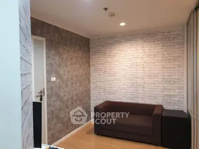 Cozy living room with modern brick accent wall and comfortable brown sofa