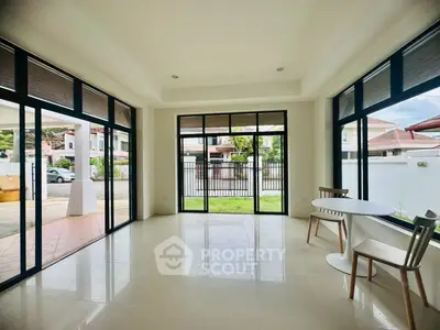 Spacious modern living room with large windows and garden view