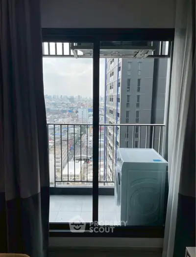 High-rise apartment balcony with city view and washing machine