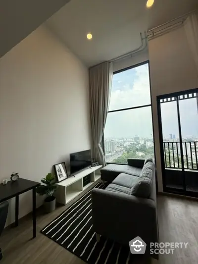 Modern living room with high ceiling and city view from balcony