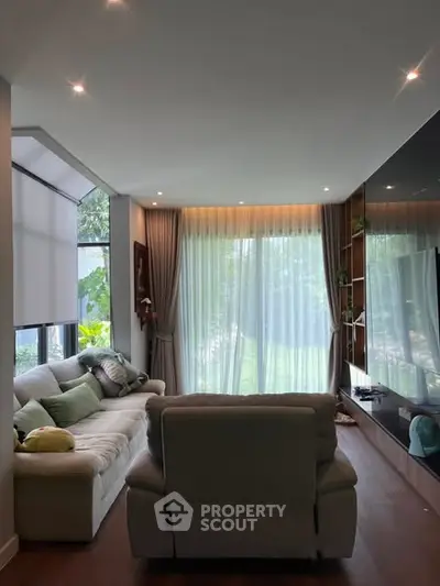 Elegant living room with large windows and modern decor