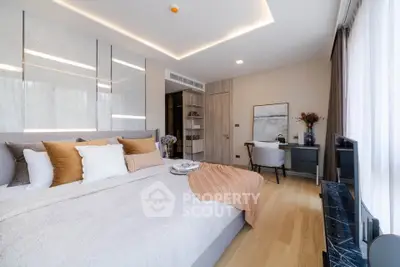 Luxurious bedroom with elegant decor and natural light, featuring a cozy study nook.