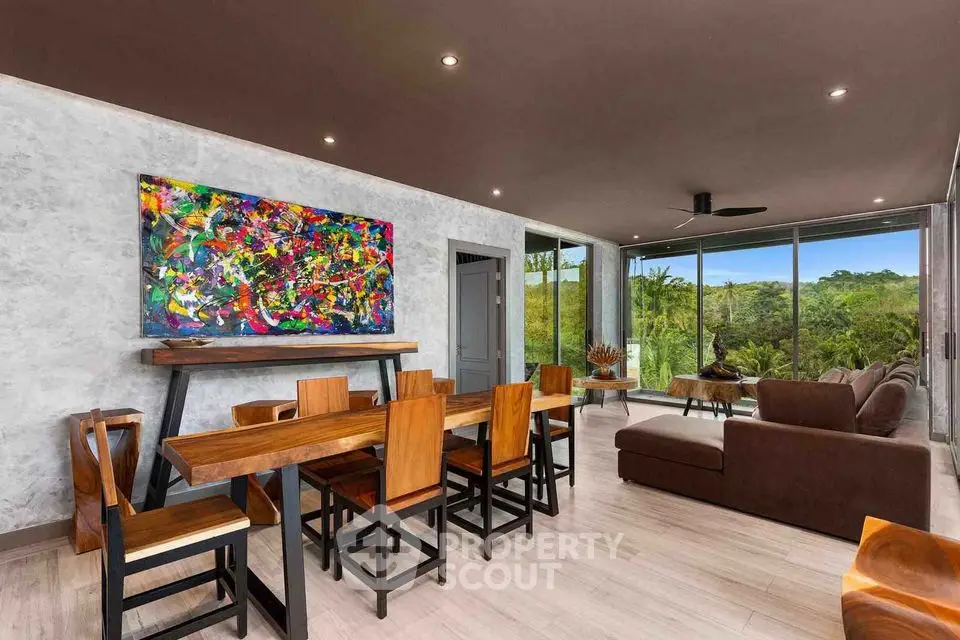 Modern living room with vibrant artwork and stunning forest view