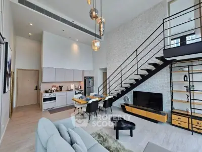 Modern loft-style living room with open kitchen and stylish staircase