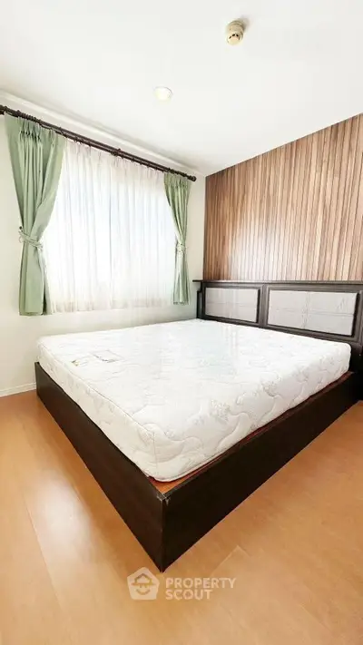 Spacious bedroom with natural light and elegant wooden accents