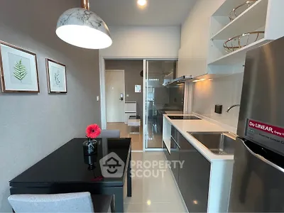 Modern kitchen with sleek design, featuring stainless steel appliances and elegant dining area.