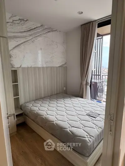 Cozy bedroom with balcony access and stylish decor