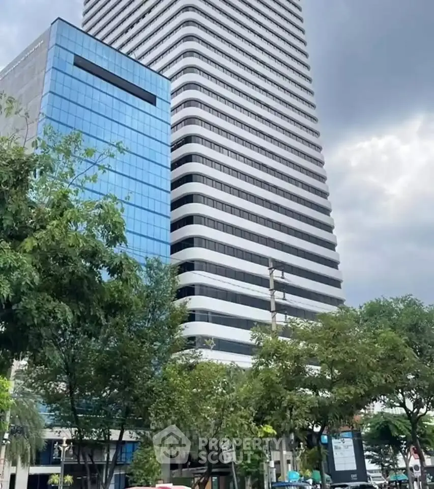 Modern high-rise building with sleek design and urban surroundings.