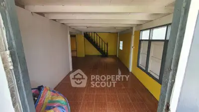 Spacious interior with tiled flooring and staircase in a cozy home