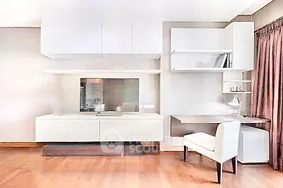 Modern living room with sleek white cabinetry and built-in desk, perfect for stylish home office setup.