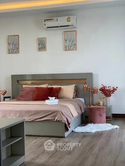 Modern bedroom with stylish decor, featuring a cozy bed, elegant lighting, and chic wall art.