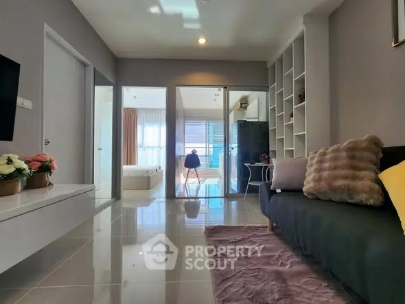 Modern living room with sleek design and cozy decor, featuring a plush sofa and stylish shelving.