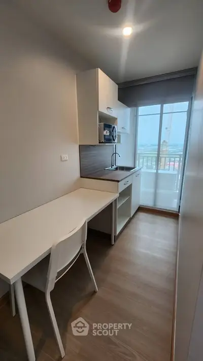 Modern compact kitchen with sleek design and city view