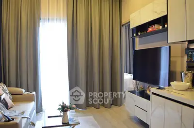 Modern living room with sleek TV unit and cozy seating area, perfect for relaxation.