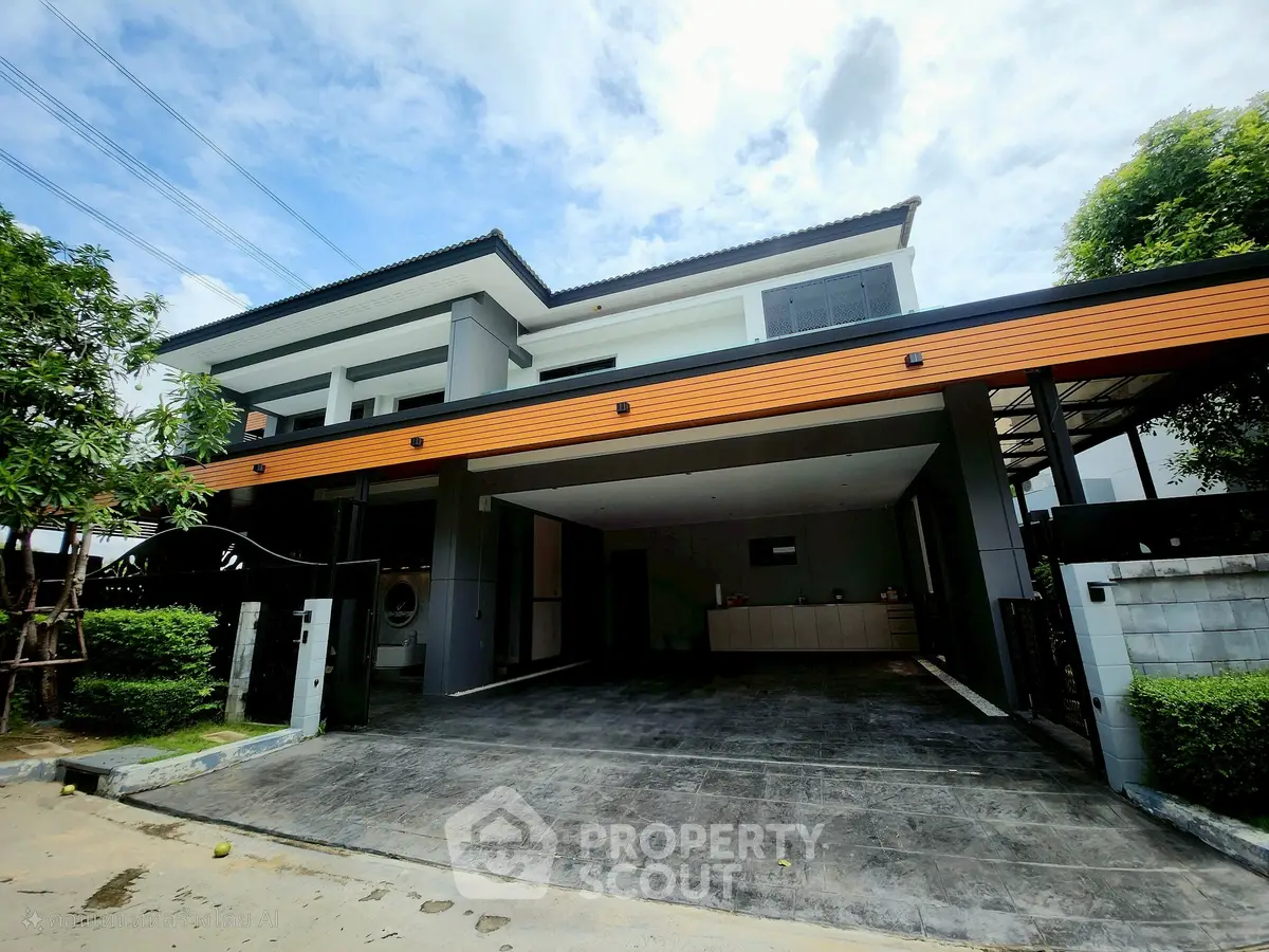 Modern two-story house with spacious driveway and sleek design