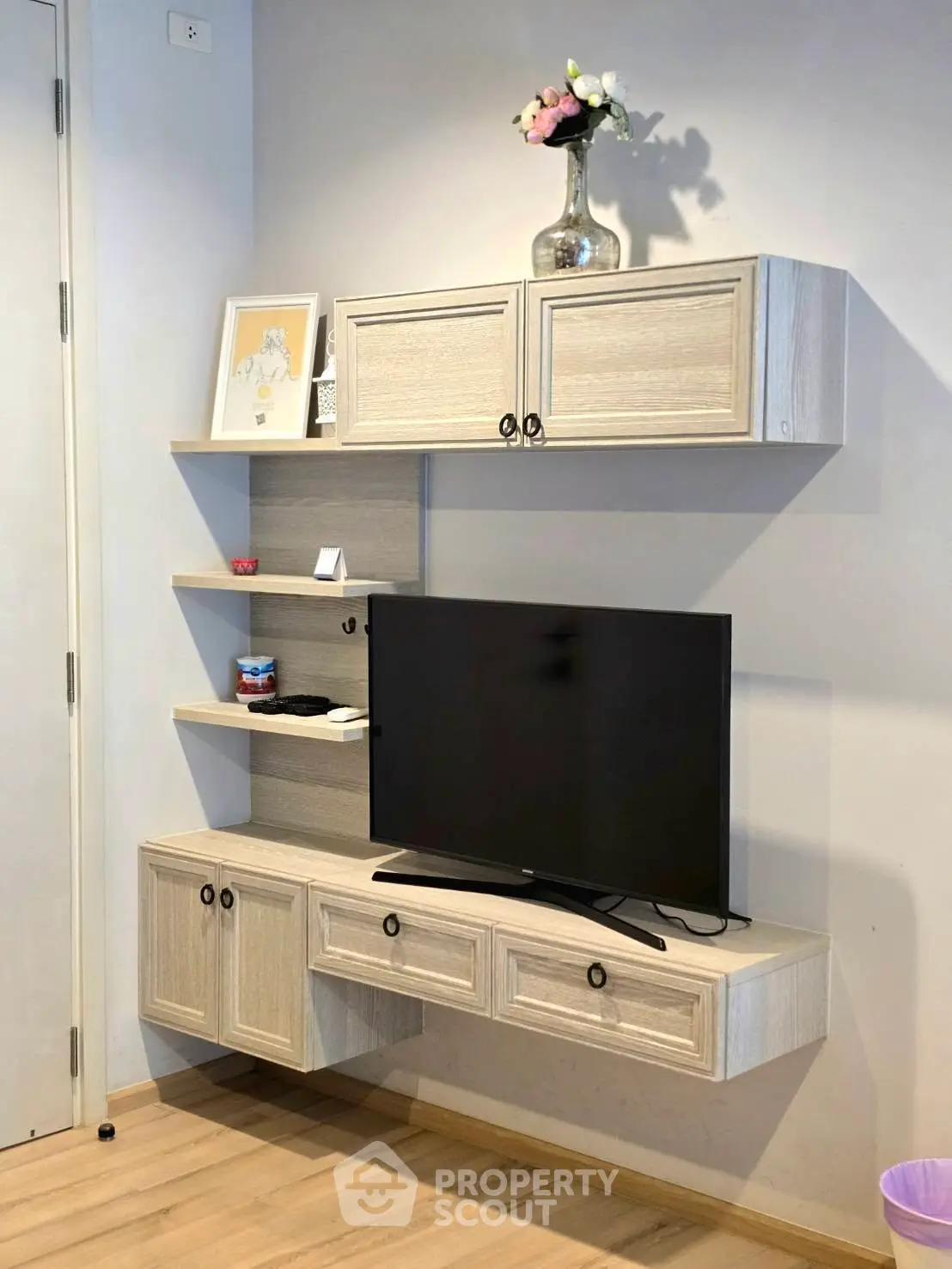 Modern living room with stylish TV cabinet and decorative shelves