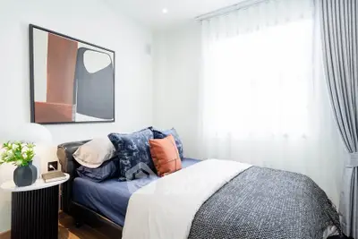 Cozy modern bedroom with stylish decor and natural light