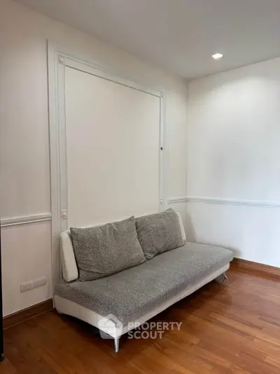 Minimalist living room with modern sofa and wooden flooring