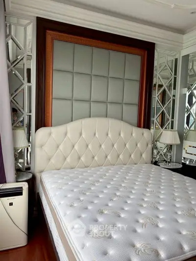 Luxurious bedroom with elegant headboard and mirrored accents