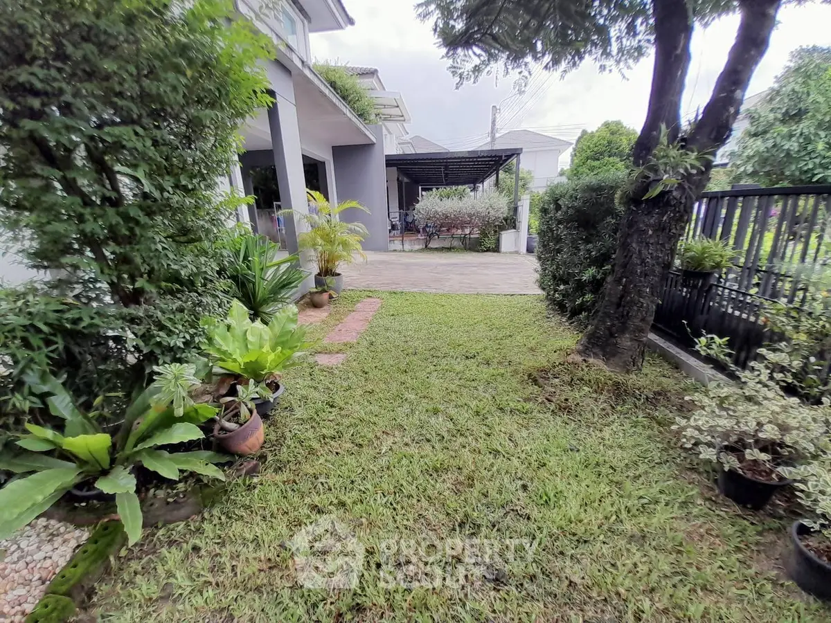 Charming garden view of a modern home with lush greenery and spacious patio.