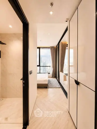 Modern apartment interior with bedroom and hallway featuring elegant design and city view.
