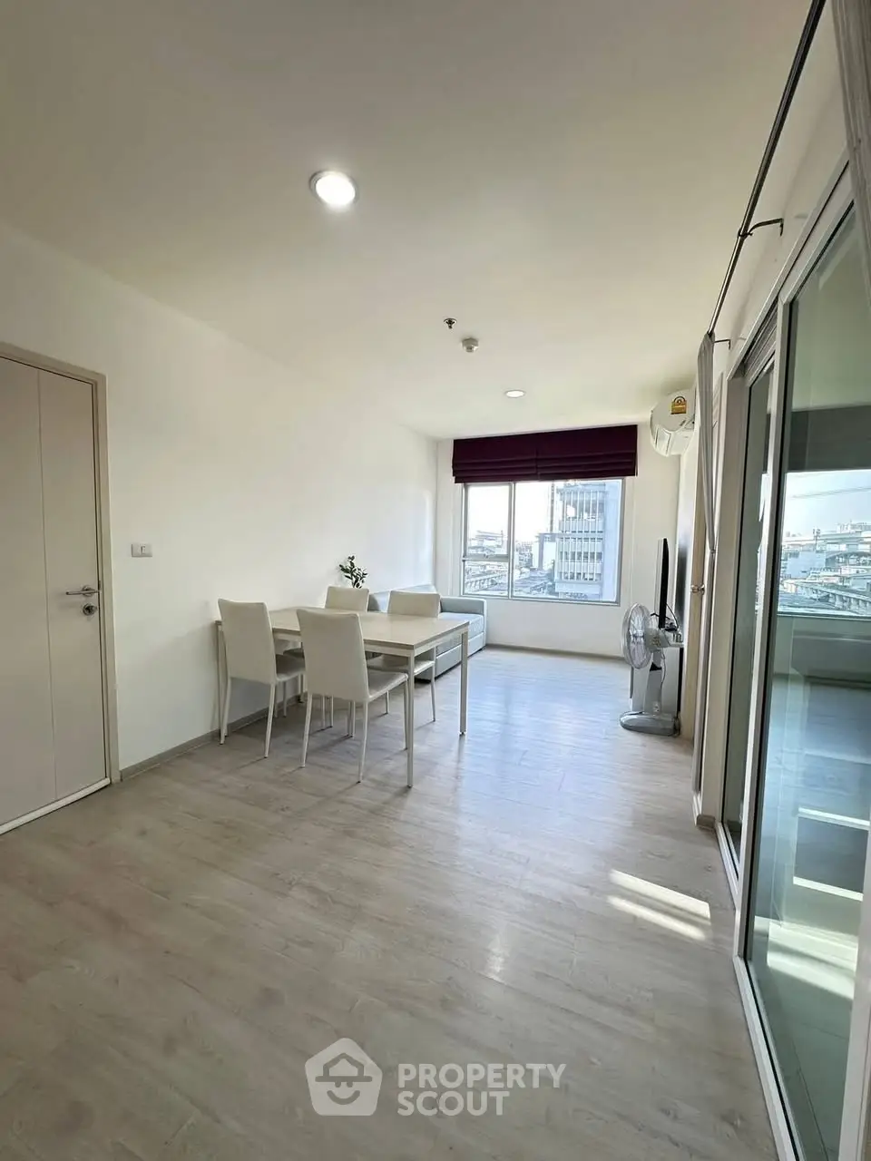 Bright and airy living room with city view and modern dining set