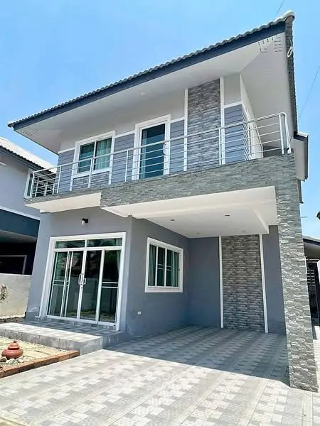 Modern two-story house with sleek balcony and spacious driveway