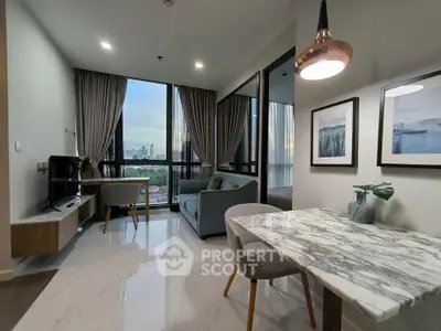 Modern living room with marble dining table and city view, featuring elegant decor and ample natural light.