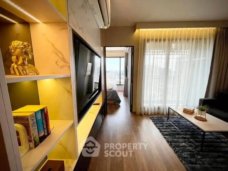 Modern living room with stylish decor and city view, featuring sleek furniture and ambient lighting.