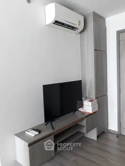 Modern living room with air conditioner and sleek TV setup