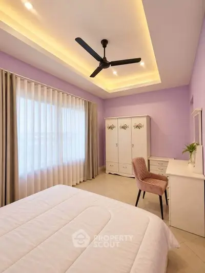 Elegant bedroom with soft purple walls, cozy bed, and stylish furniture, perfect for relaxation and comfort.