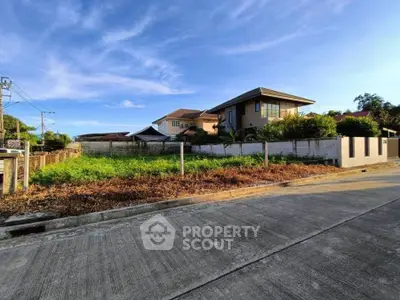 Spacious residential plot with modern house and lush greenery