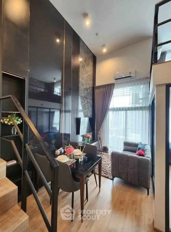 Modern loft-style living room with high ceilings and elegant decor